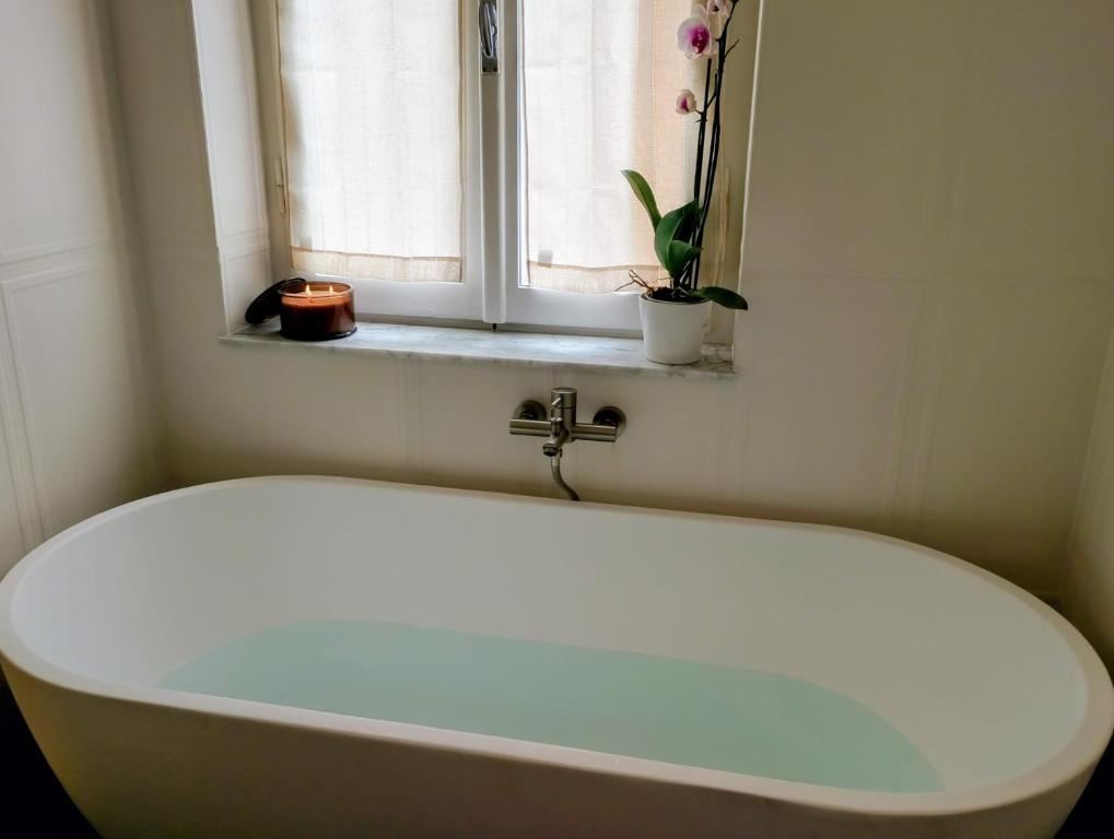 Vasca da bagno freestanding con candela accesa a Libertà Home